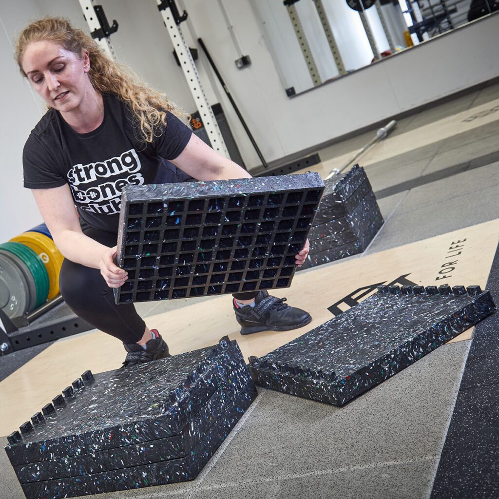 Woman stacking DC Blocks in a gym